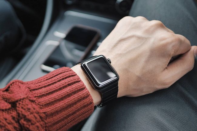 Black Apple Watch on a wrist.