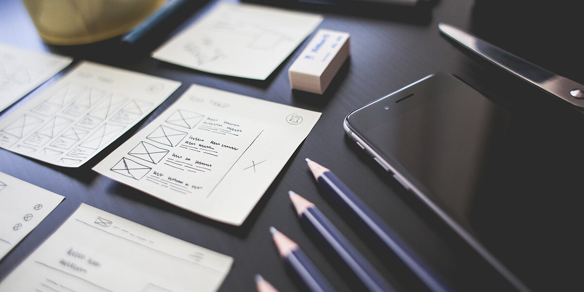 Website design sketches and phone.