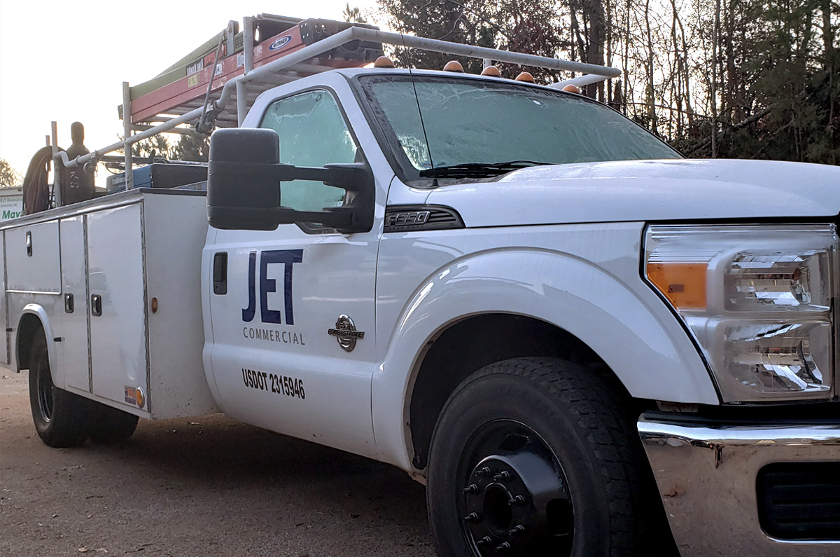 A white color Truck with the logo